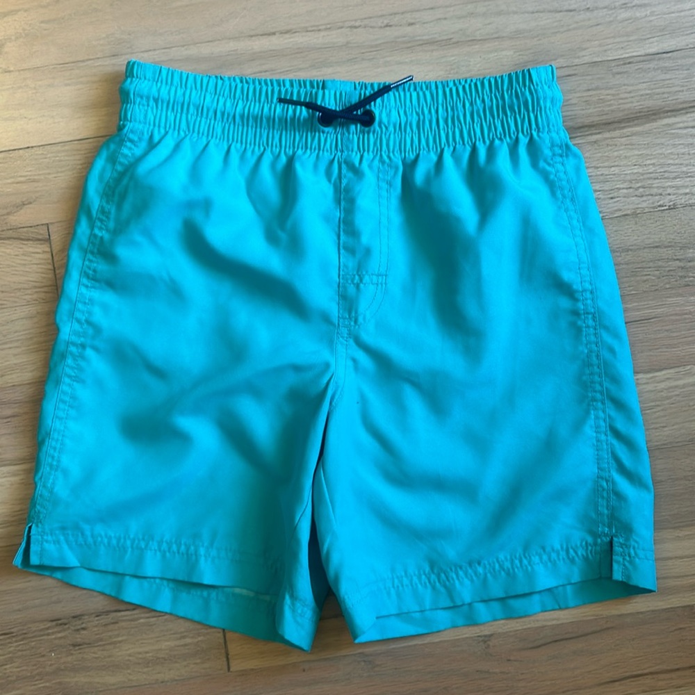Old Navy teal swim trunks with navy drawstring. Size 10/12